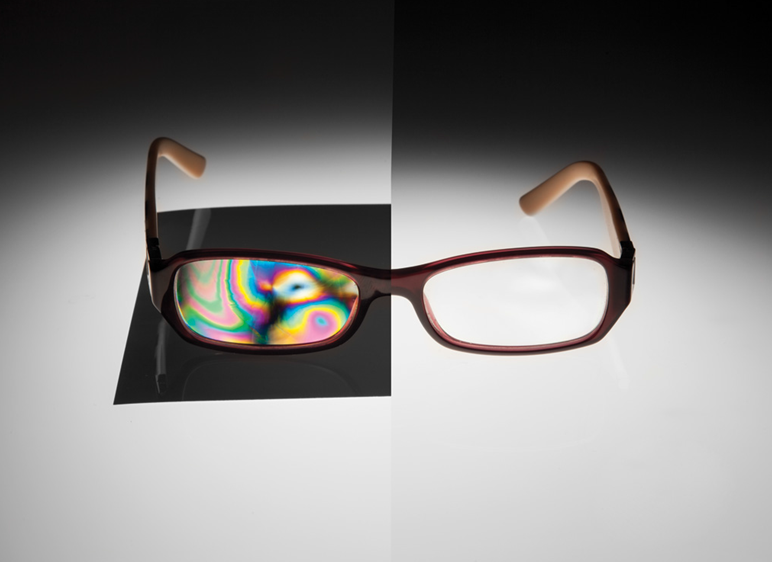 Figure 12: A pair of glasses appears clear without polarization; however, the use of polarizers makes visible the material stress variations and they appear as color variations.</h5>